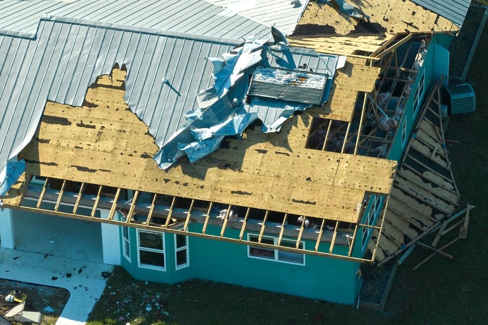 An aerial view of a house that has been damaged by a storm
