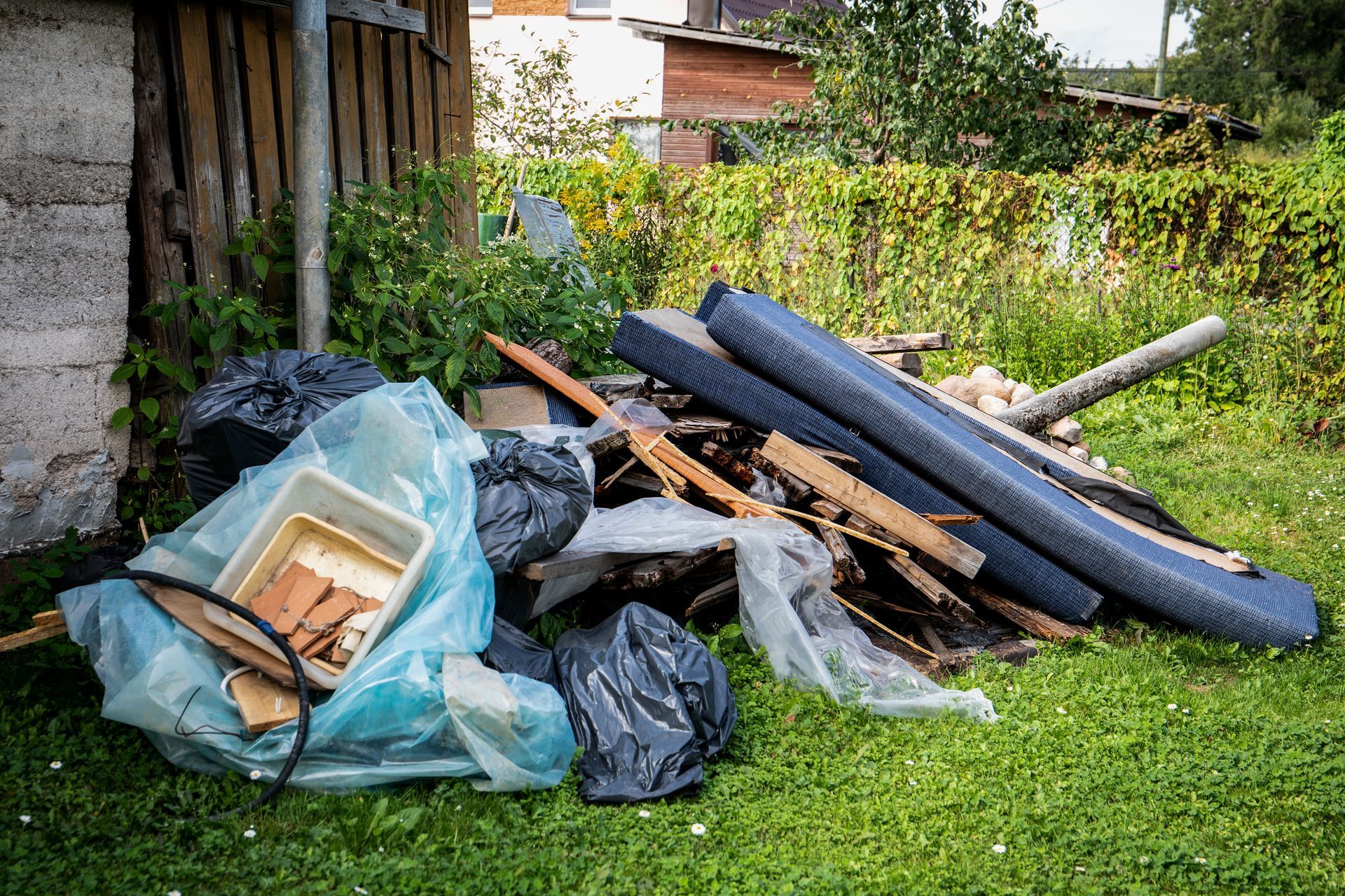 a pile of trash is sitting on top of a lush green lawn .