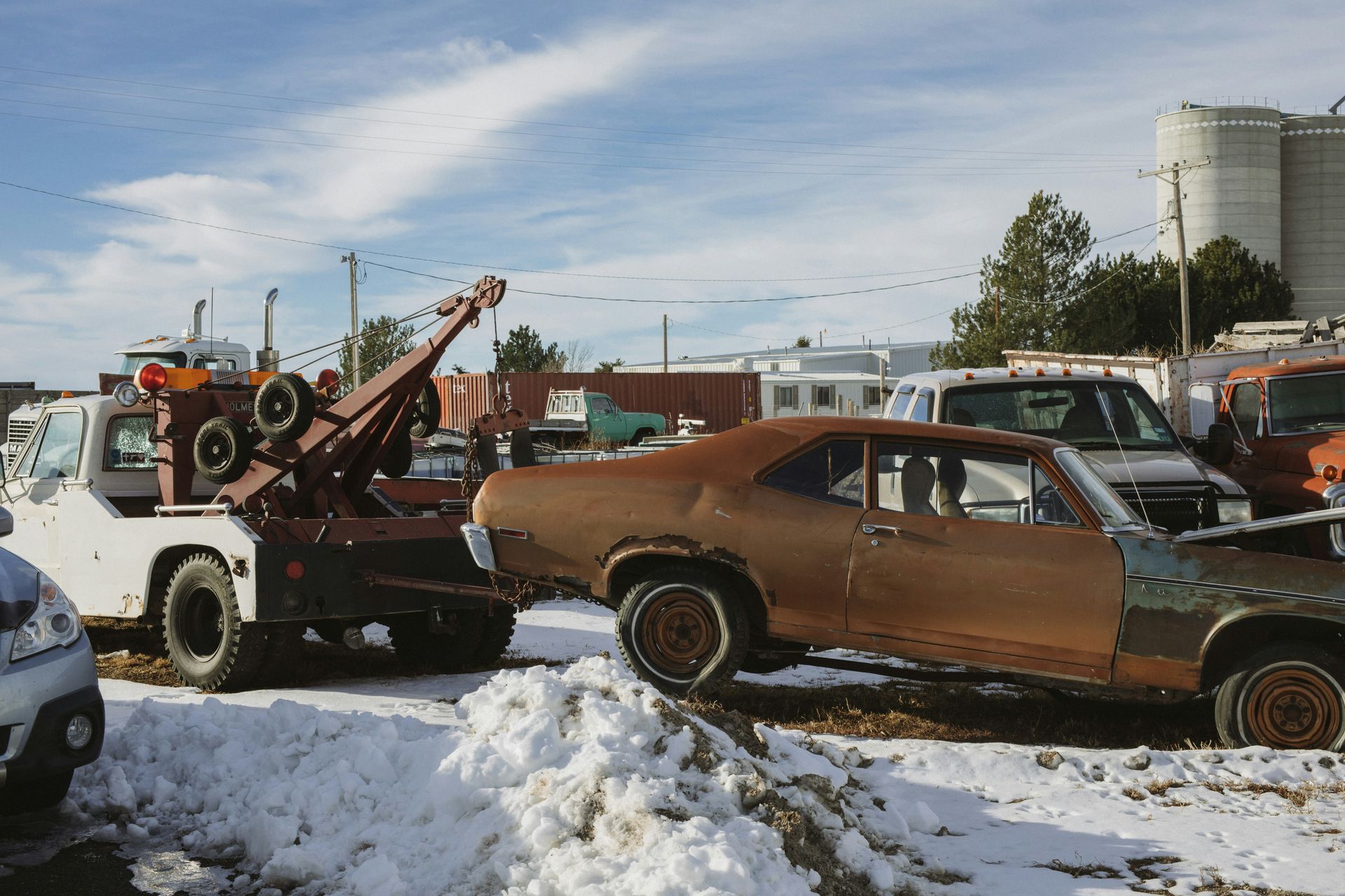 A tow truck picking up a car