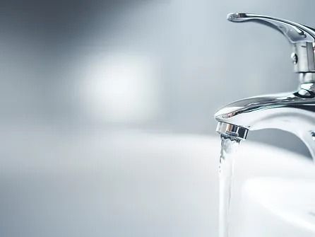 A close up of a faucet with water running out of it.