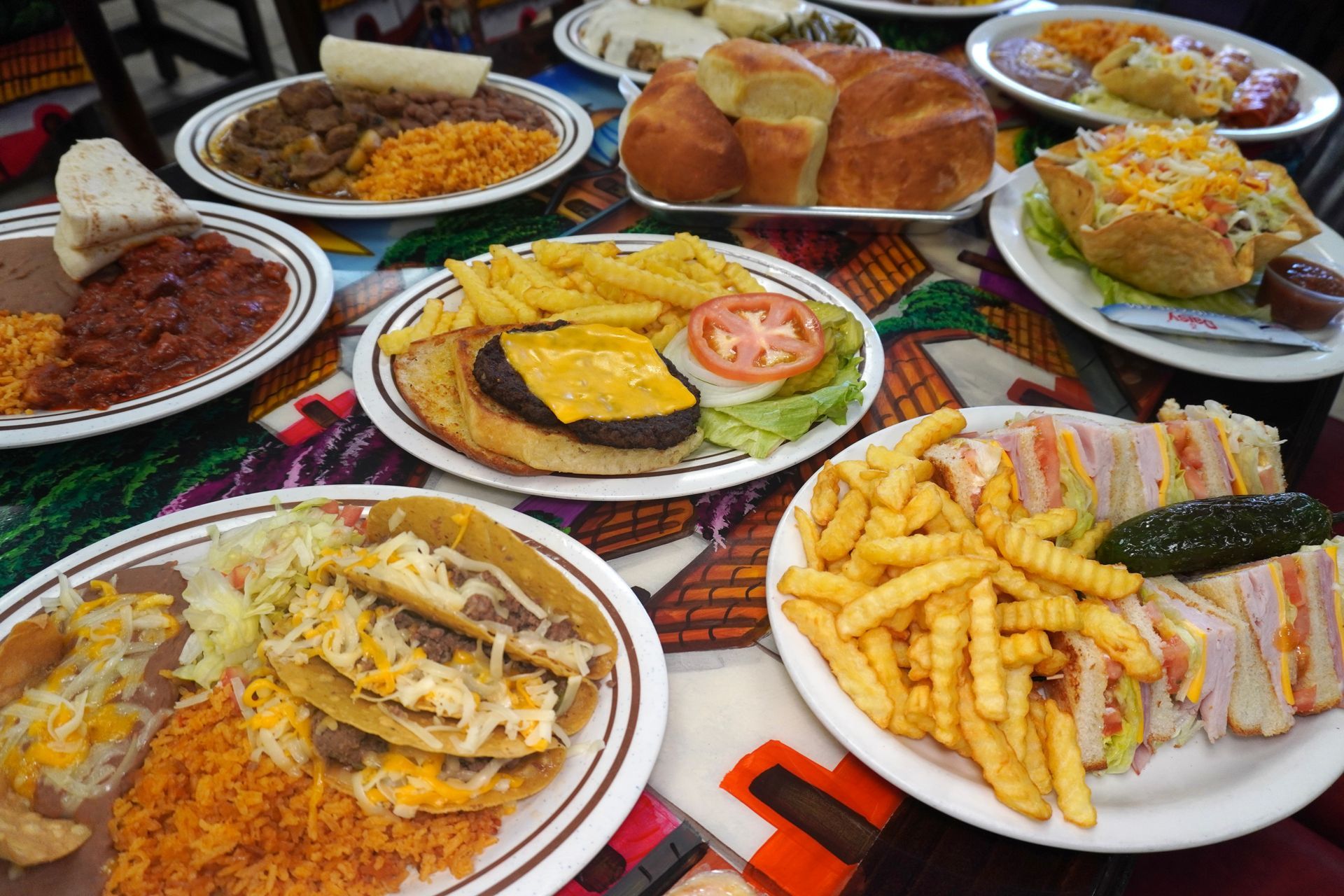 A cafeteria-style hot food buffet line featuring various trays of prepared meals like meatloaf, mashed potatoes, and gravy.
