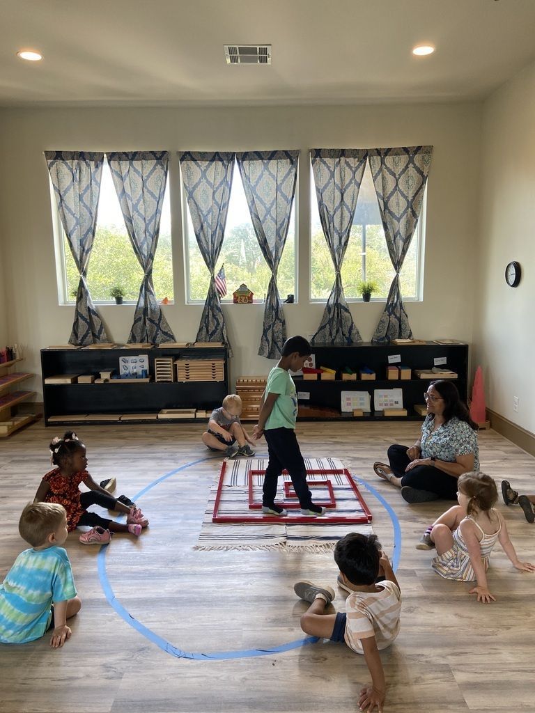 Children sitting in a circle on a classroom rug during a group activity