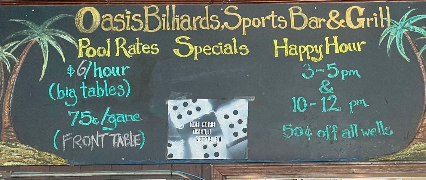 Chalkboard sign for Oasis Billiards Sports Bar & Grill with pool rates and happy hour specials.