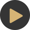 A gold play button in a black circle on a white background.