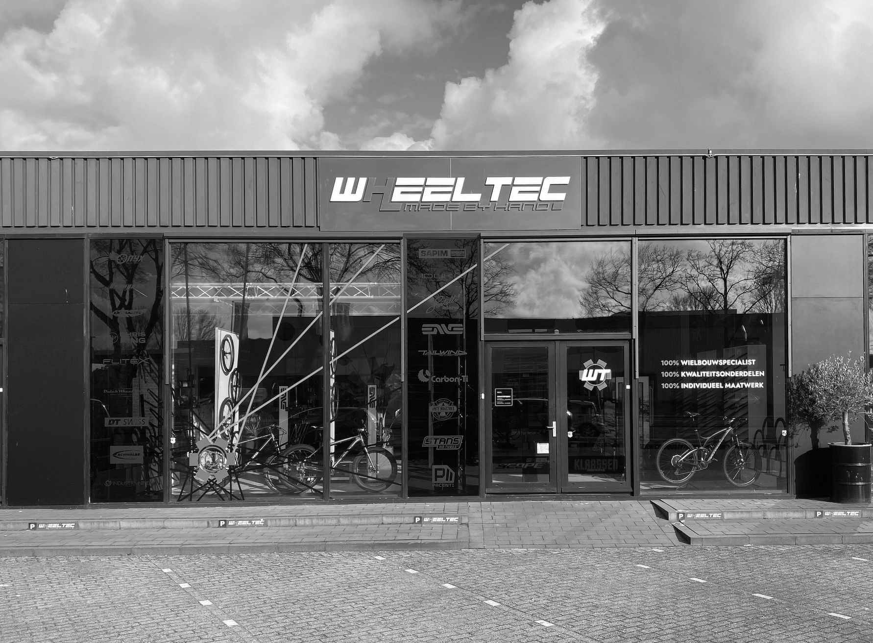 A black and white photo of a bicycle company with showroom, Tailwind and Wheel-Tec