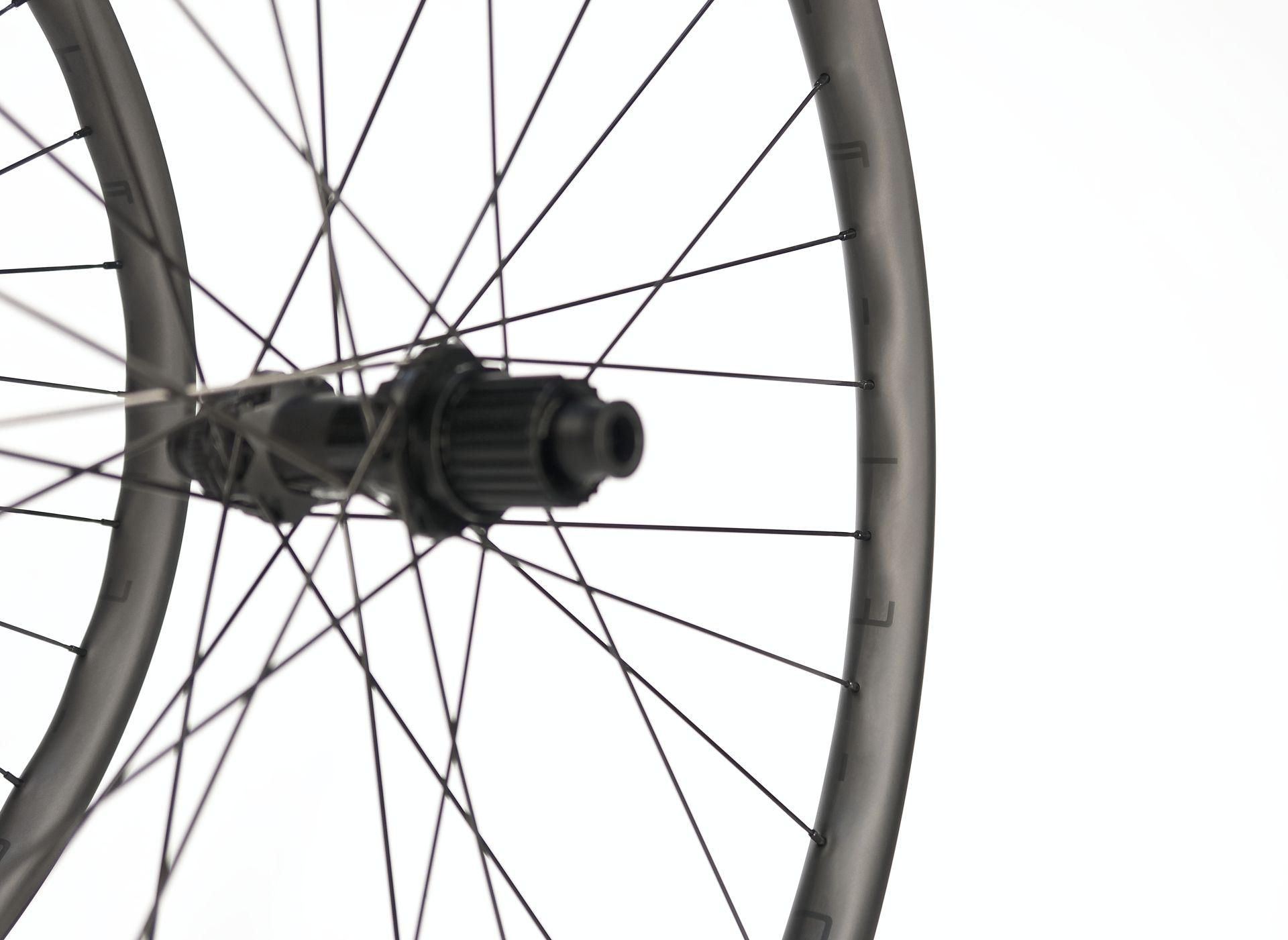 Close-up of Tailwind bicycle wheel with dark rim, spokes, and hub, against a white background.