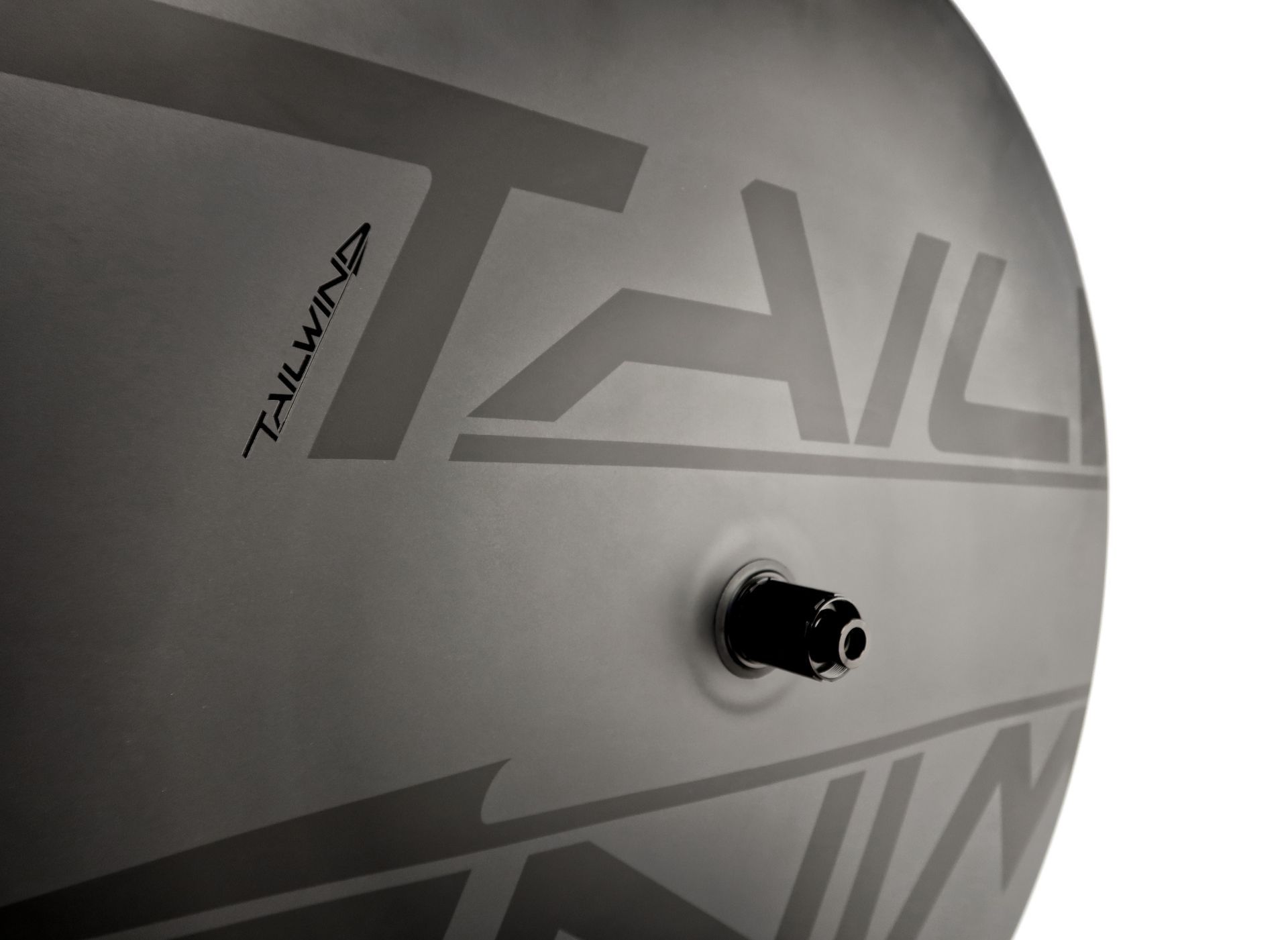 A close up of a carbon disc closed aero bicycle wheel for time trial and triathlon