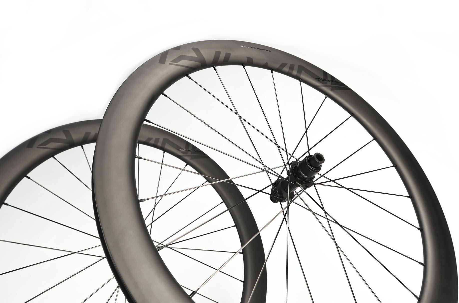 A close up of a carbon aero bicycle wheelset for road bikes