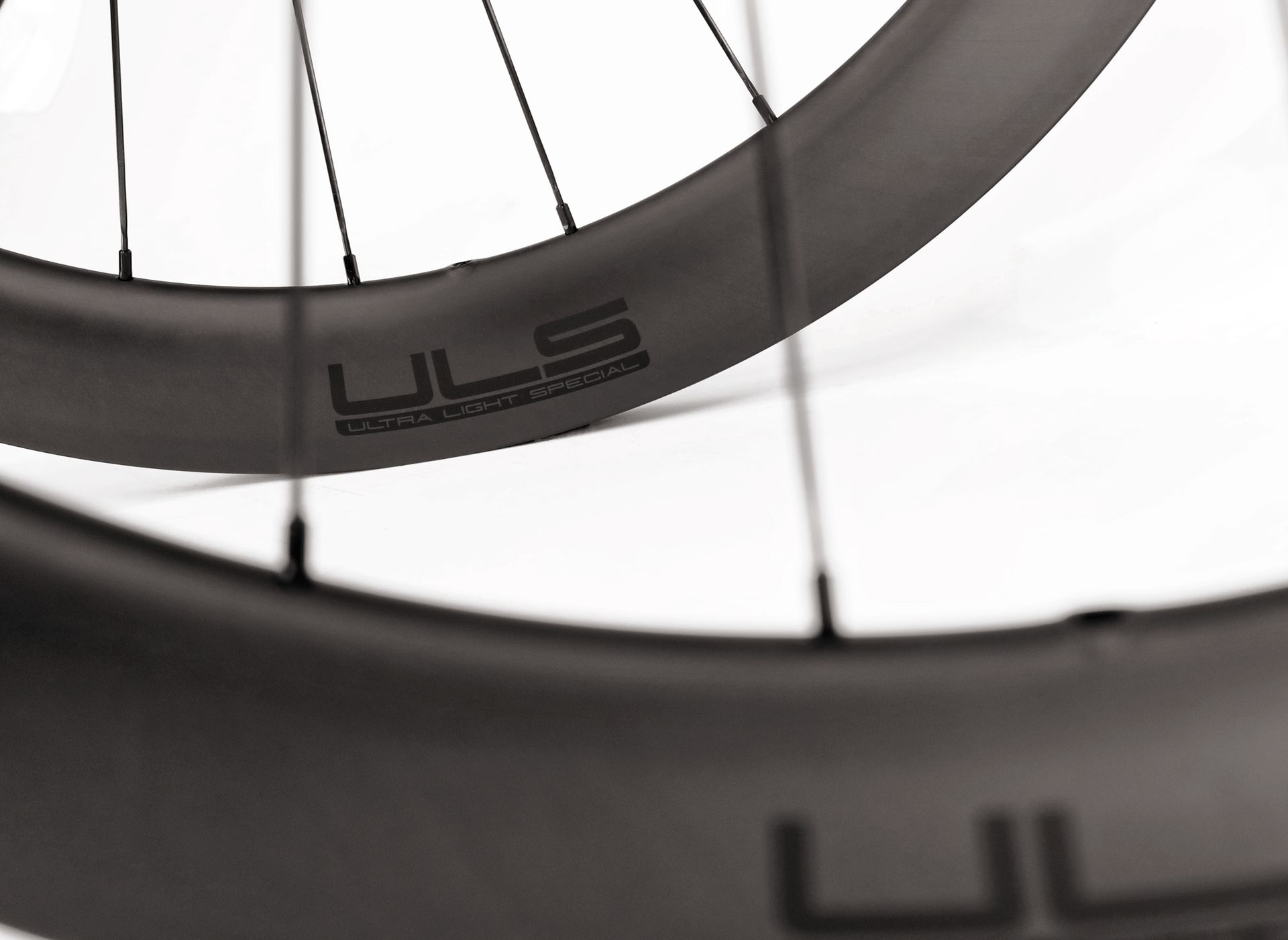 A close up of a pair of Tailwind carbon aero uls bicycle wheels
