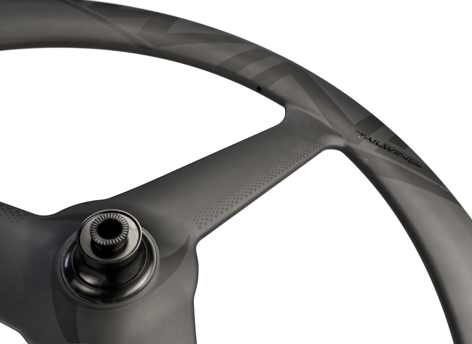 Close-up of a black carbon fiber triathlon wheel with a three-spoke design.