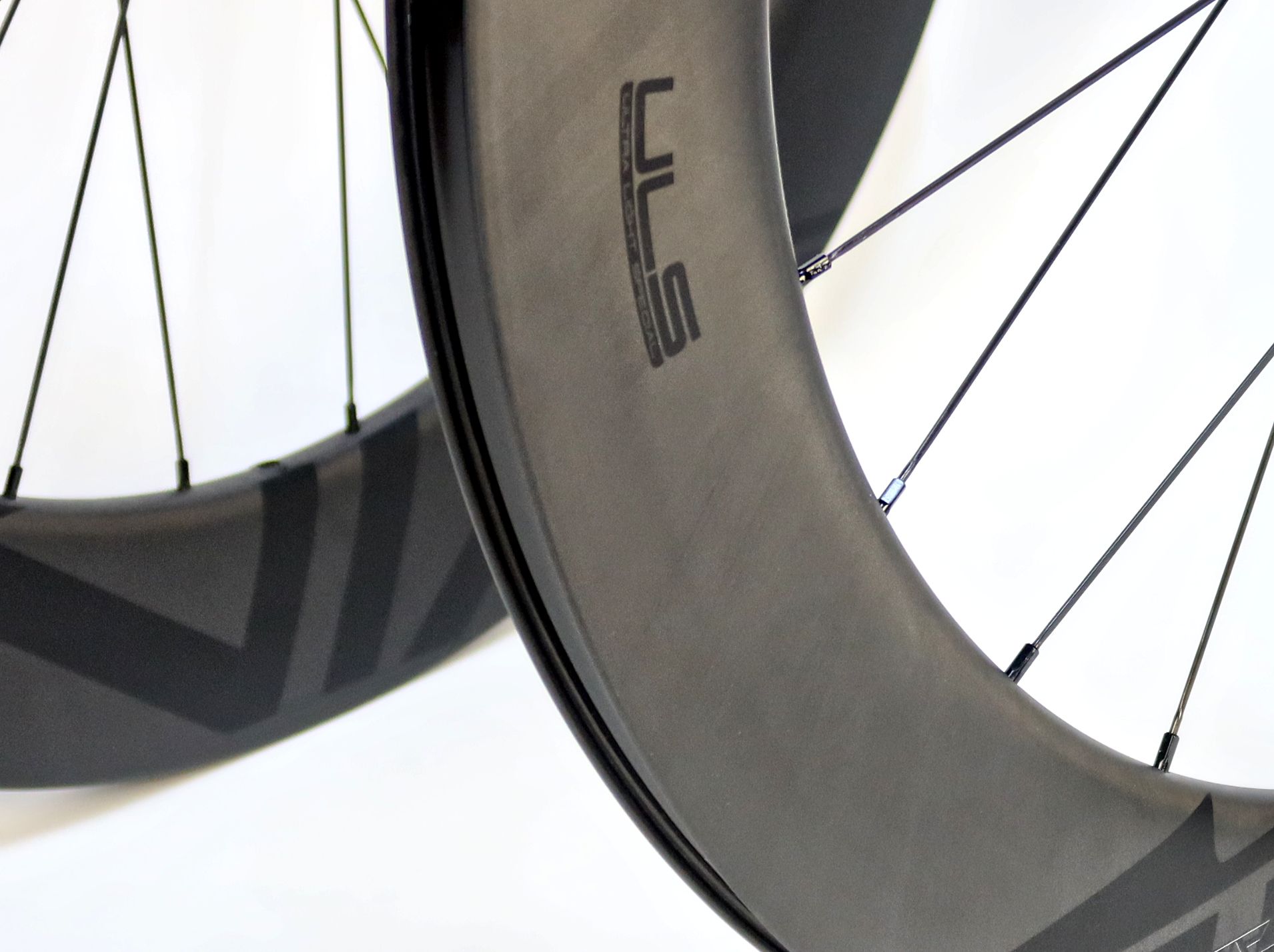 A close up of an aero carbon Tailwind bicycle wheel with logo