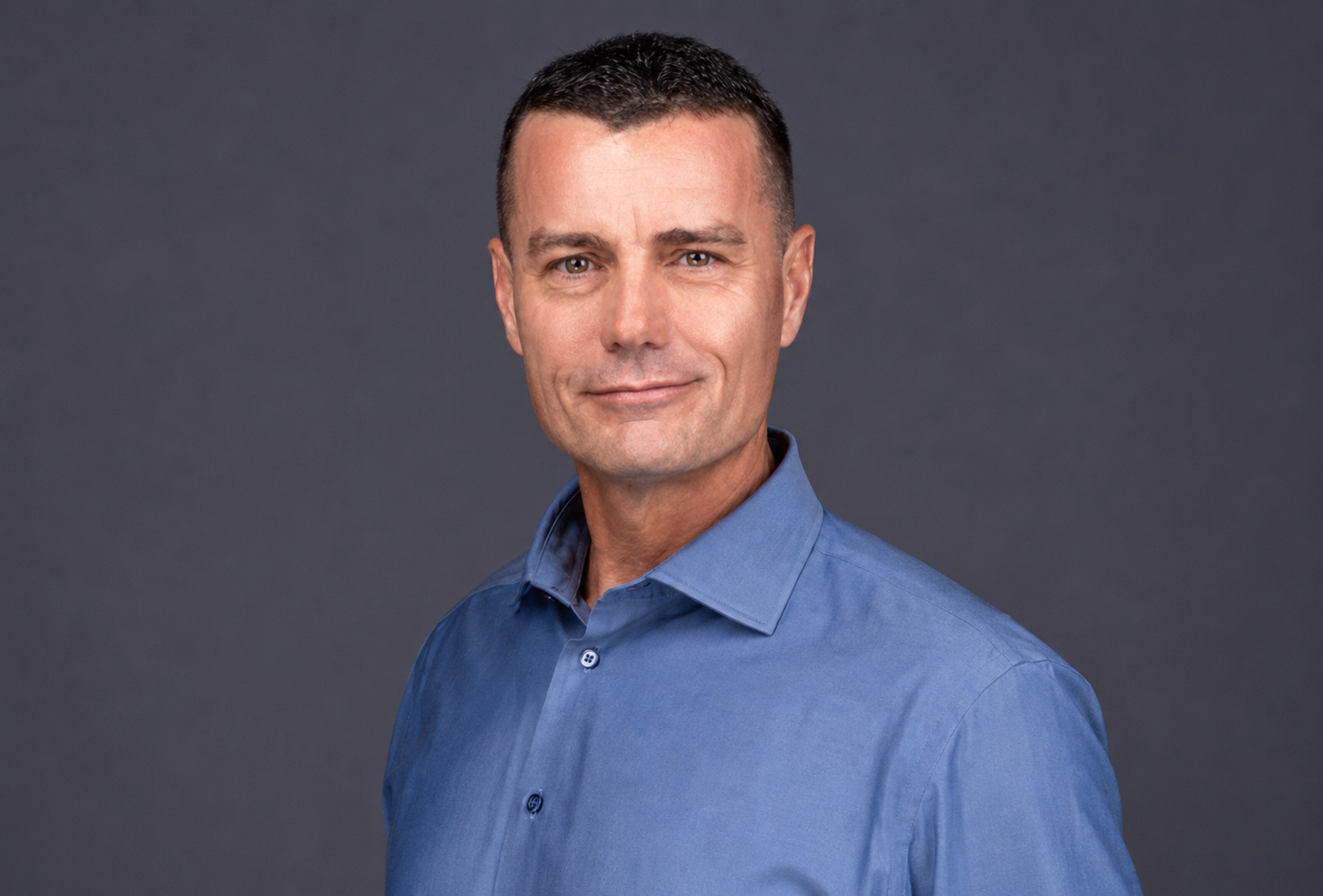 Bill Schauman Personal Injury Lawyer CA  Portrait of a man in a blue shirt against a dark gray background