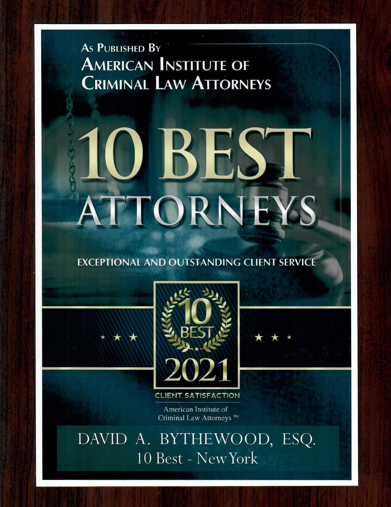 A book titled 10 best attorneys is on a wooden table.