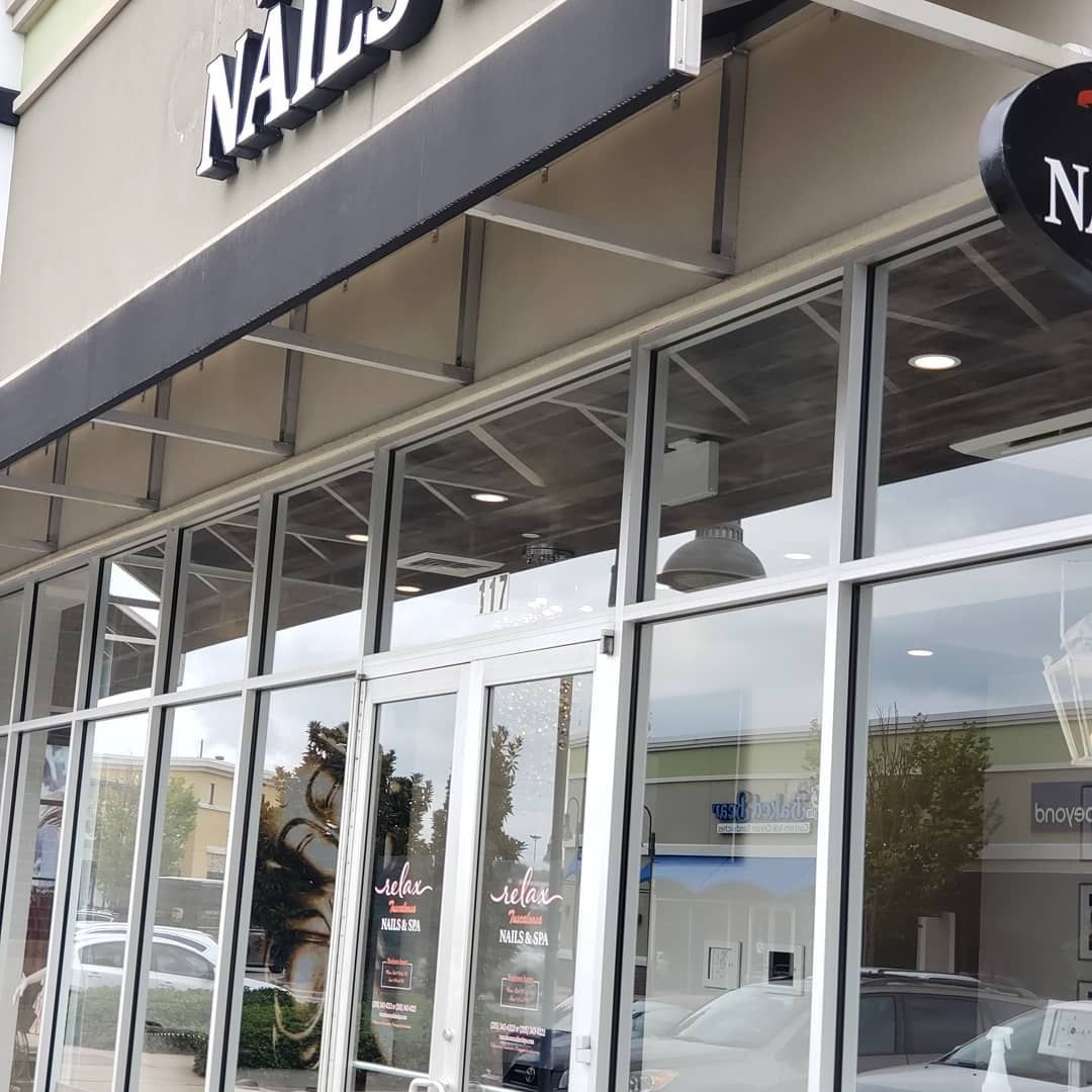 A building with a sign that says nails on it