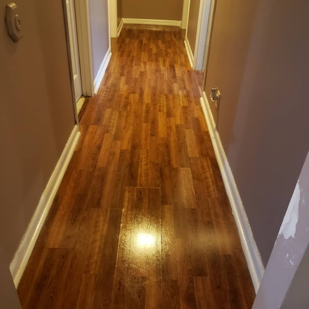 A hallway with hardwood floors in a house.