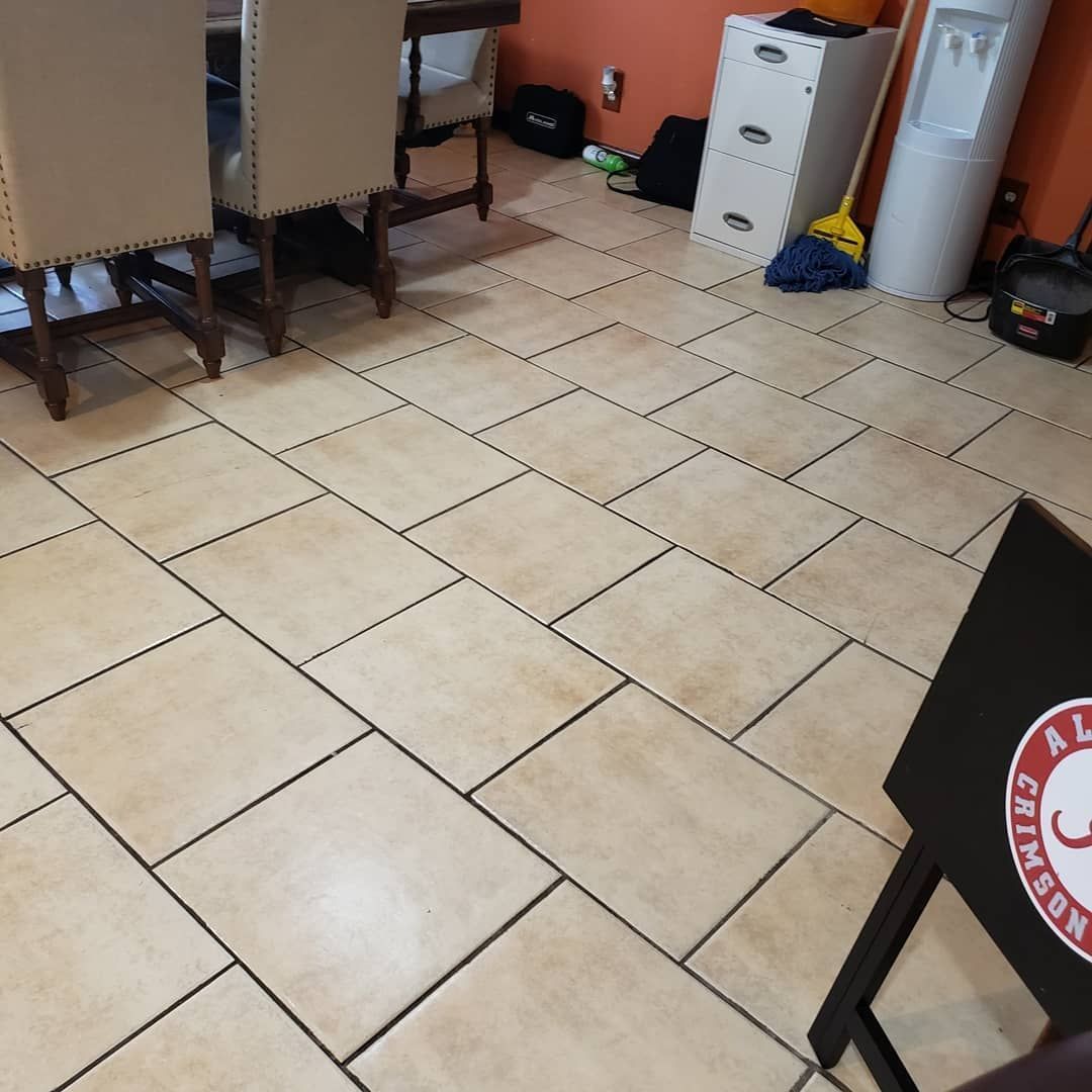 A dining room with a tiled floor and a chair with a sticker on it that says ' a ' on it