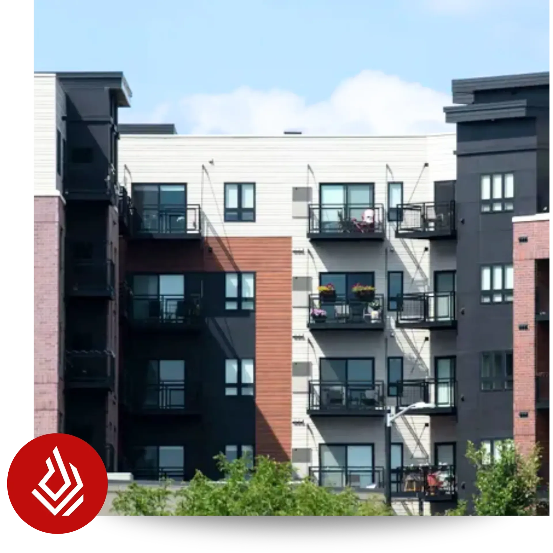 Exterior view of a modern multi-story apartment building featuring balconies and mixed-colored facades