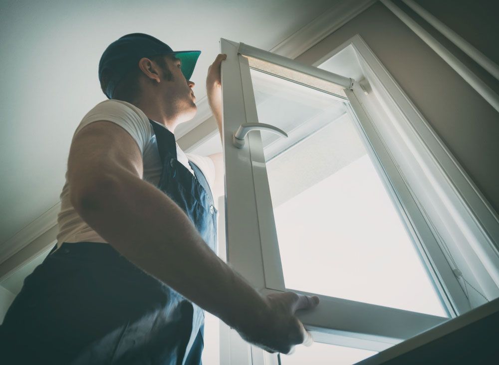 Man Installing a Glass Window — Capitol Glass in Taminda, NSW