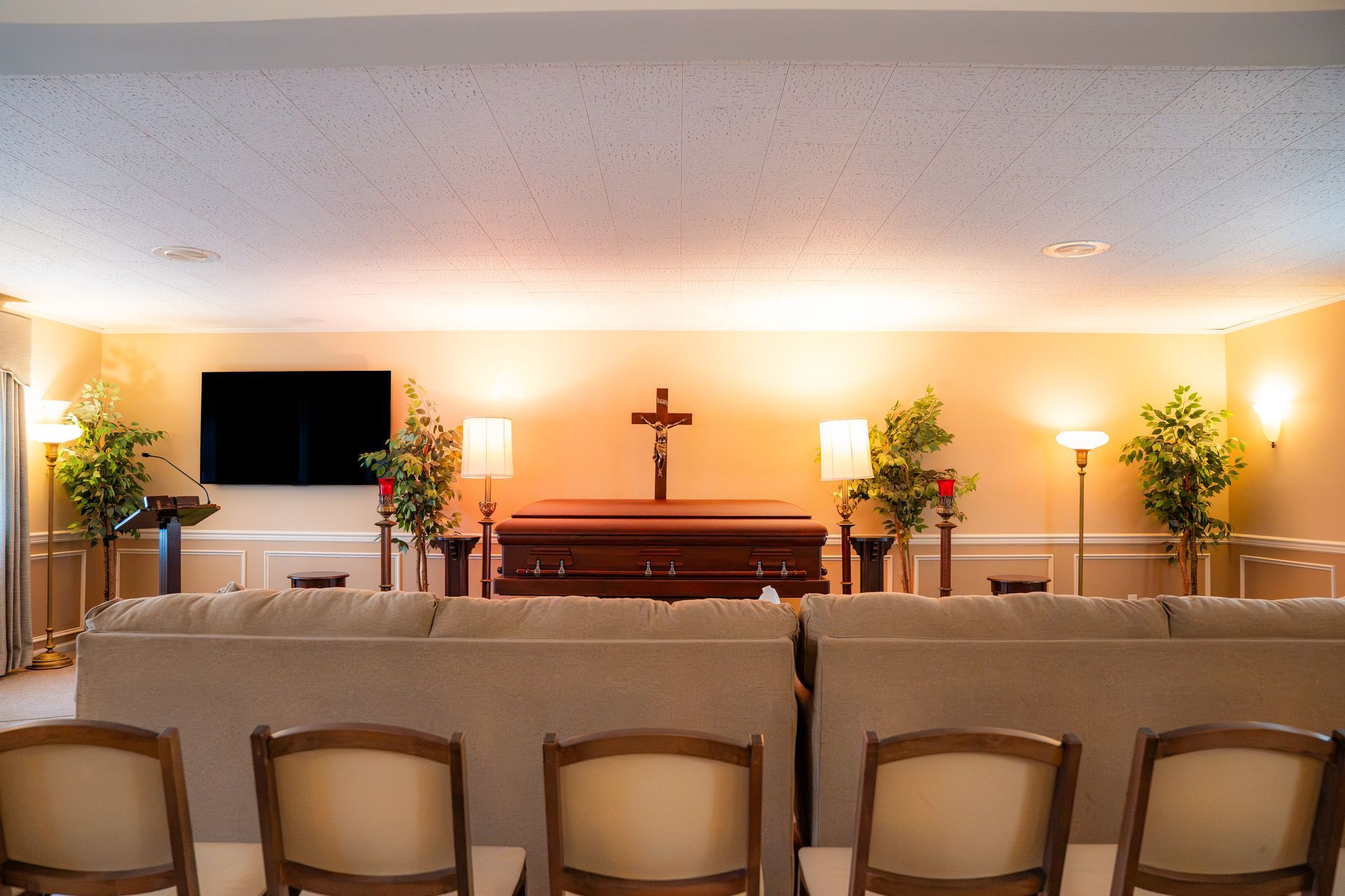 A wooden coffin with flowers on top of it in a church.