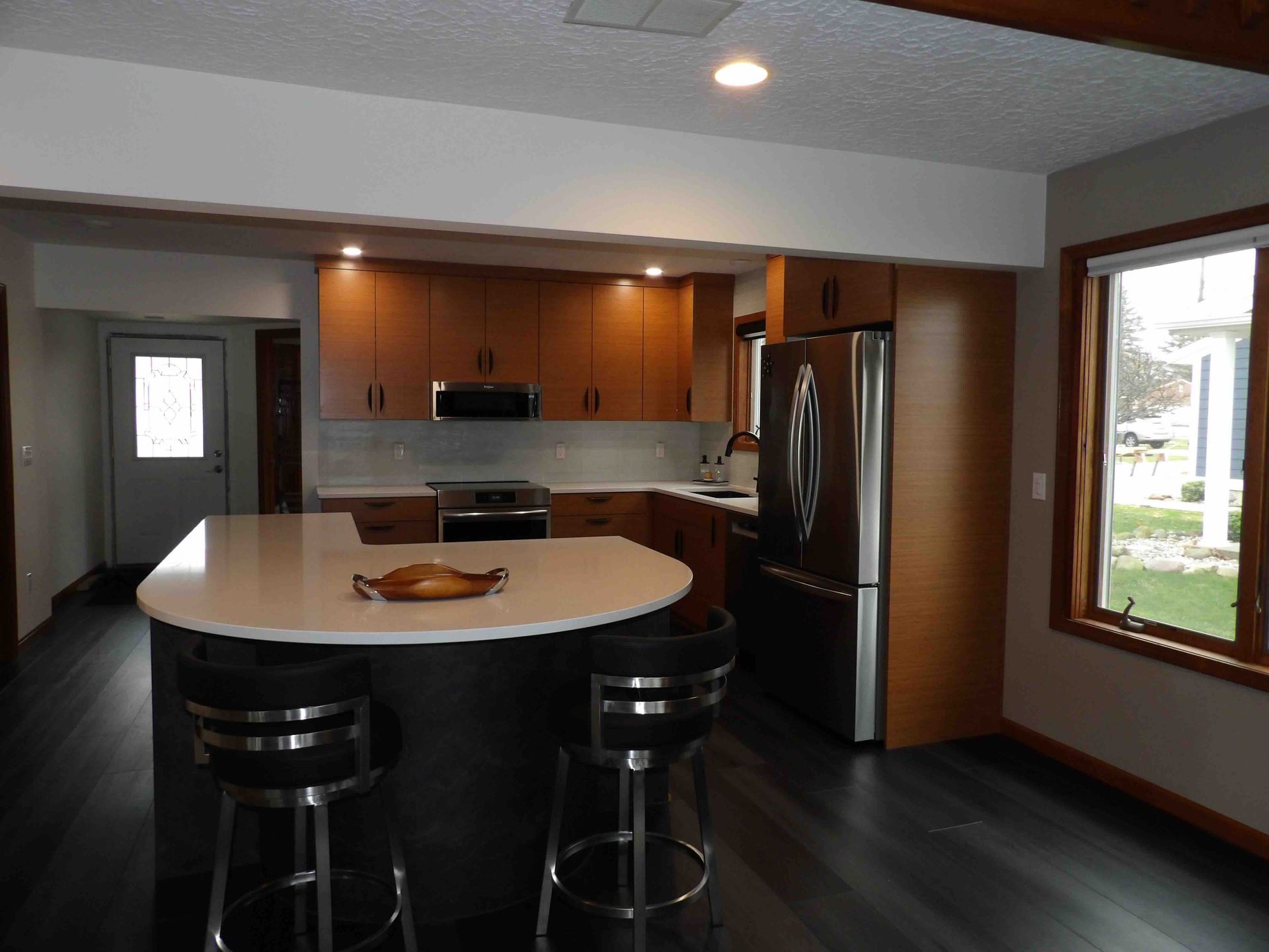 A kitchen with a large island and stools