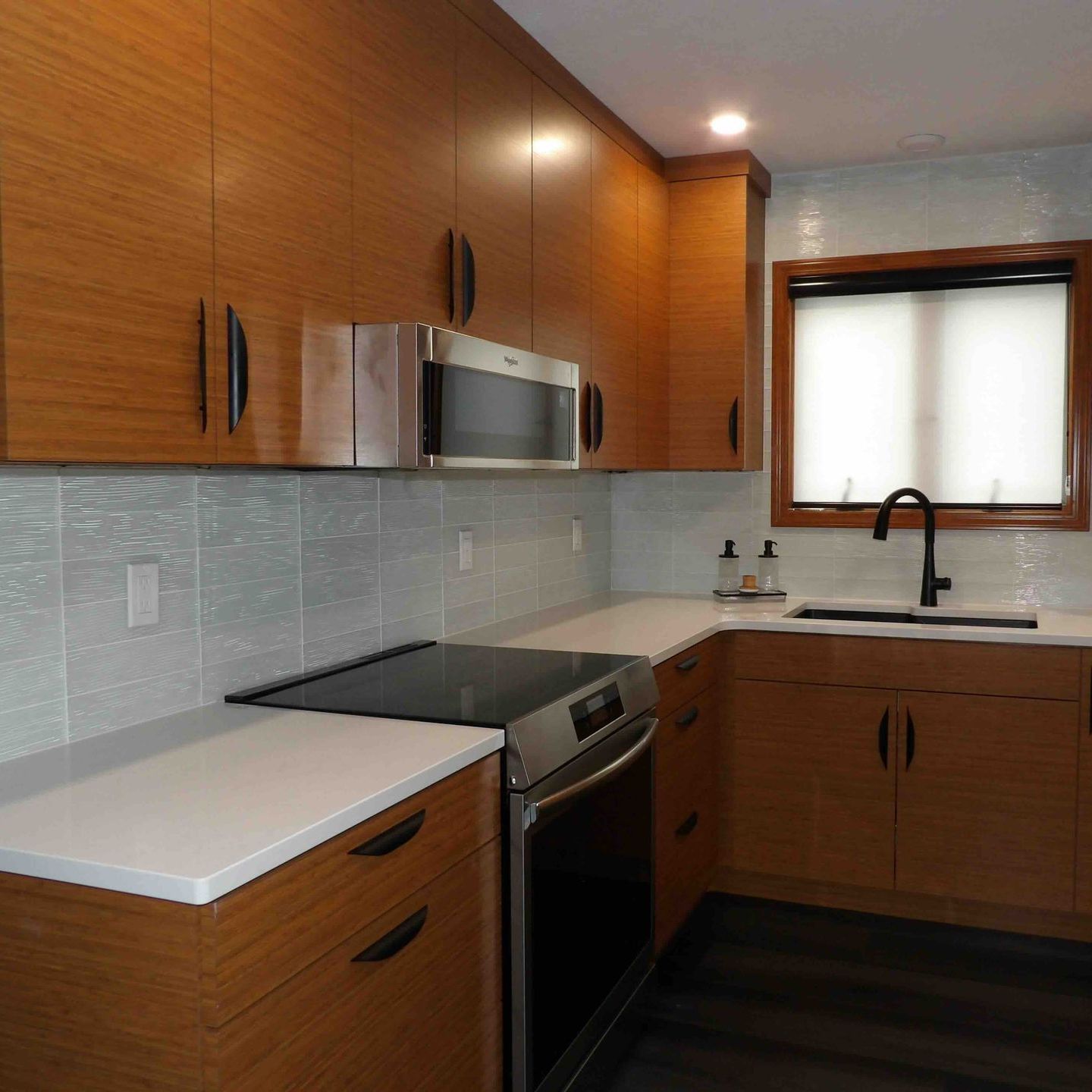 A kitchen with stainless steel appliances and wooden cabinets