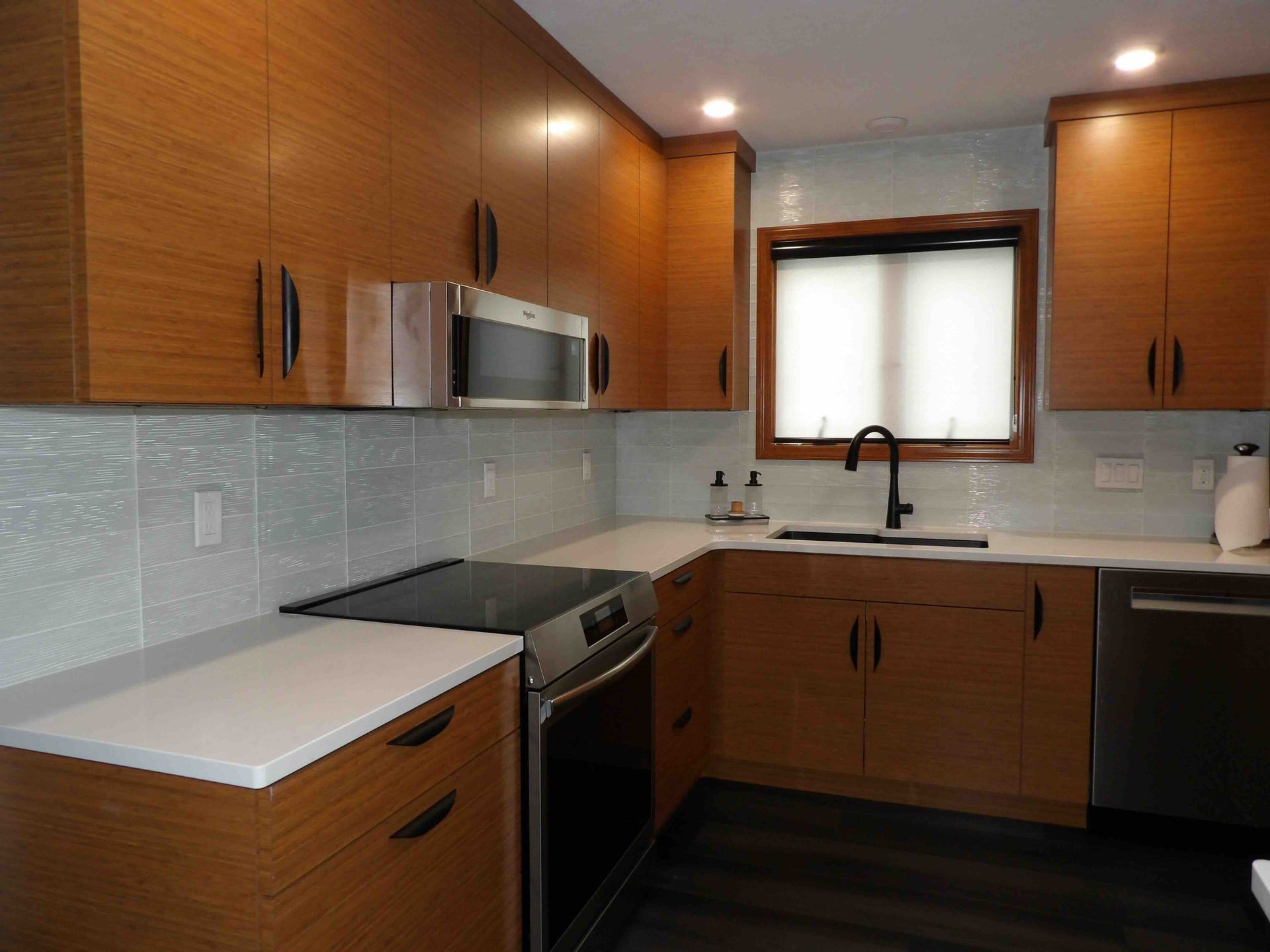 A kitchen with wooden cabinets and stainless steel appliances