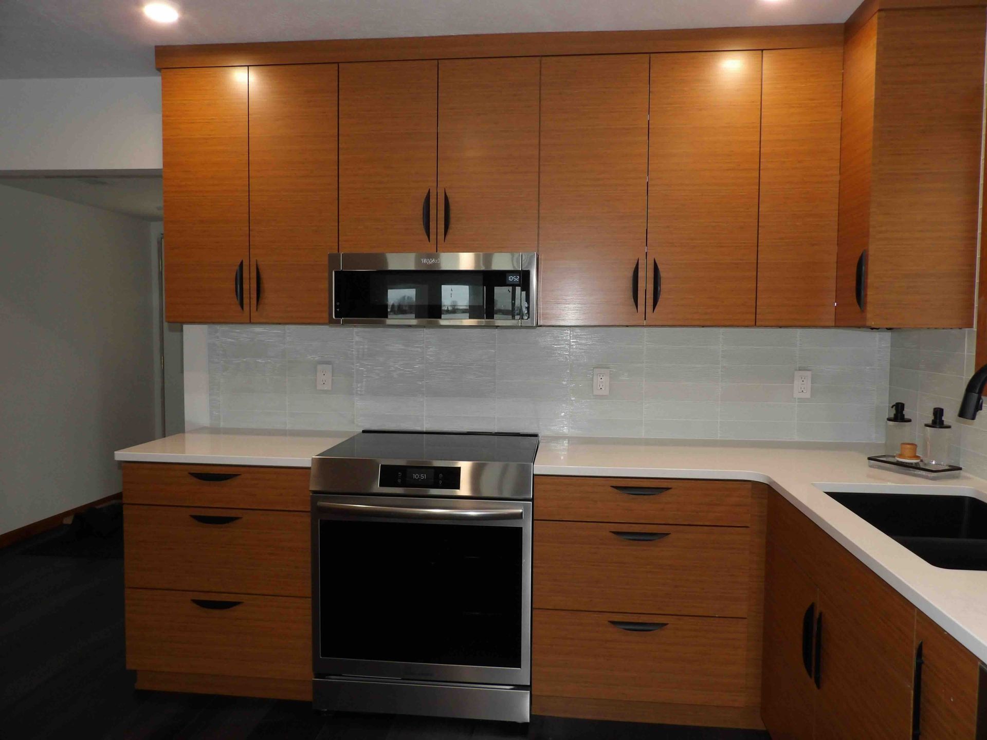 A kitchen with wooden cabinets and stainless steel appliances