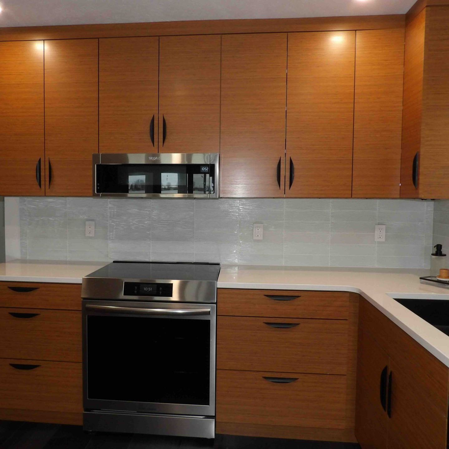 A kitchen with wooden cabinets and stainless steel appliances