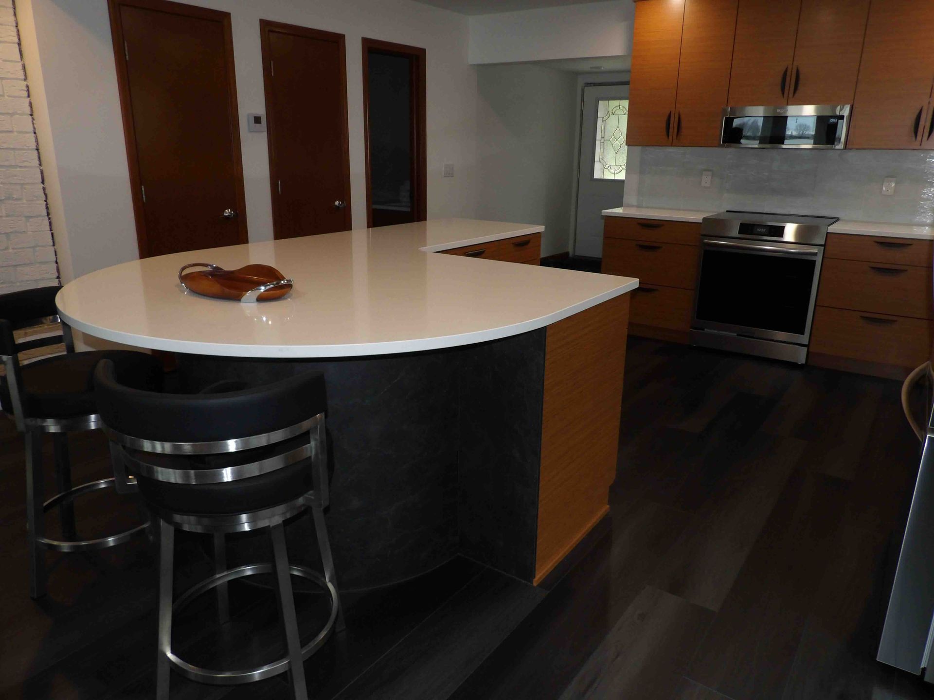 A kitchen with a large island and stools