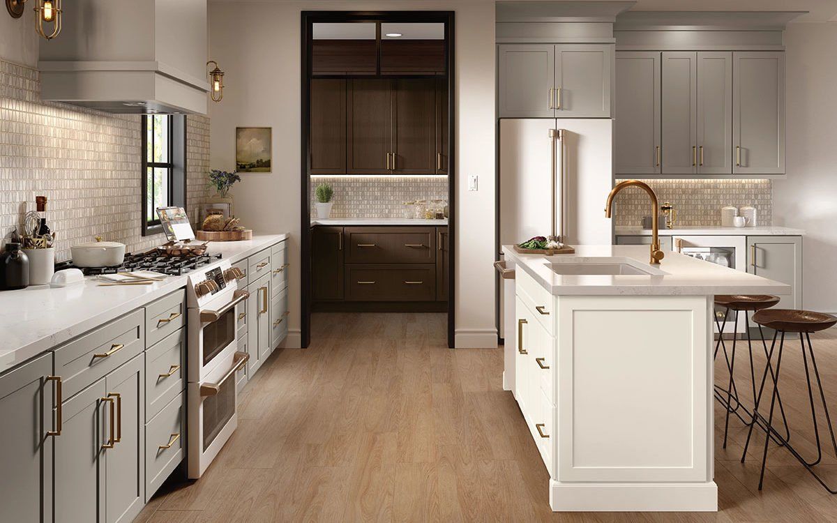 A kitchen with white cabinets , stainless steel appliances , and a large island.