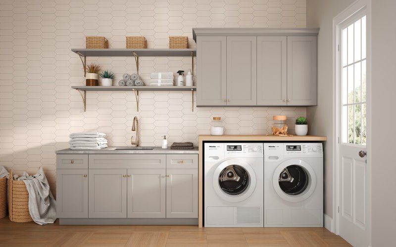 A laundry room with a washer and dryer and a sink.