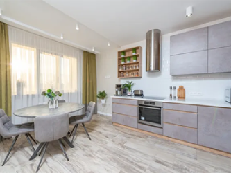 A kitchen with a table and chairs in it.