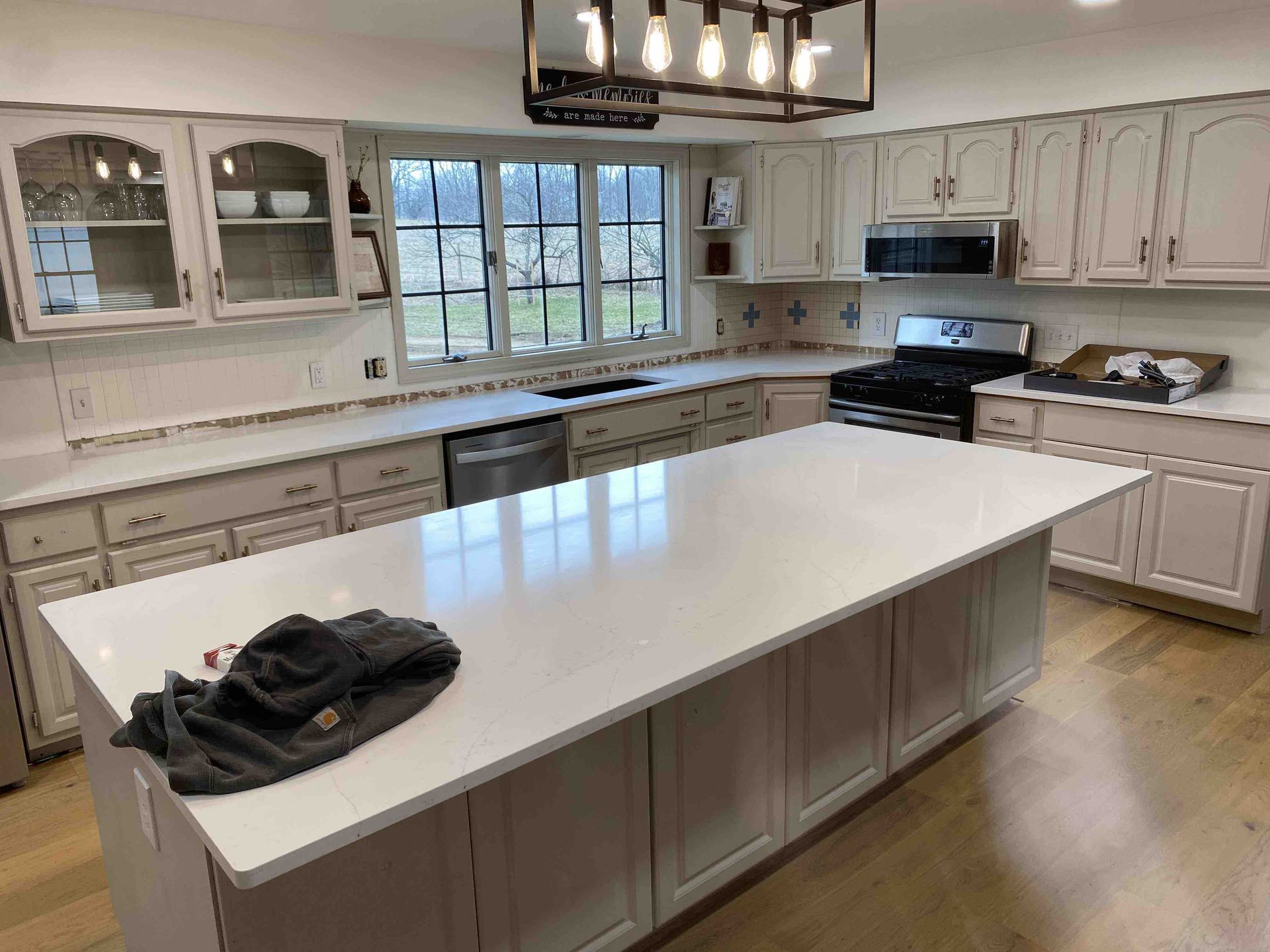 There is a large island in the middle of the kitchen.