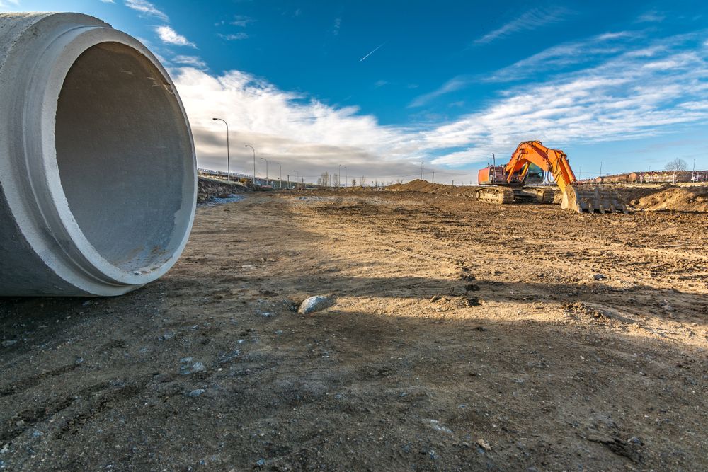 Concrete Pipe on a Construction Site With Excavator — STJ Earthmoving in Chillagoe, QLD
