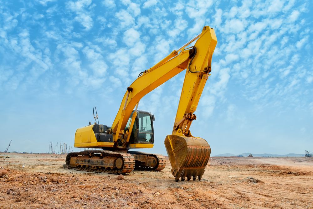 Yellow Excavator on a Dirt Ground — STJ Earthmoving in Kuranda, QLD