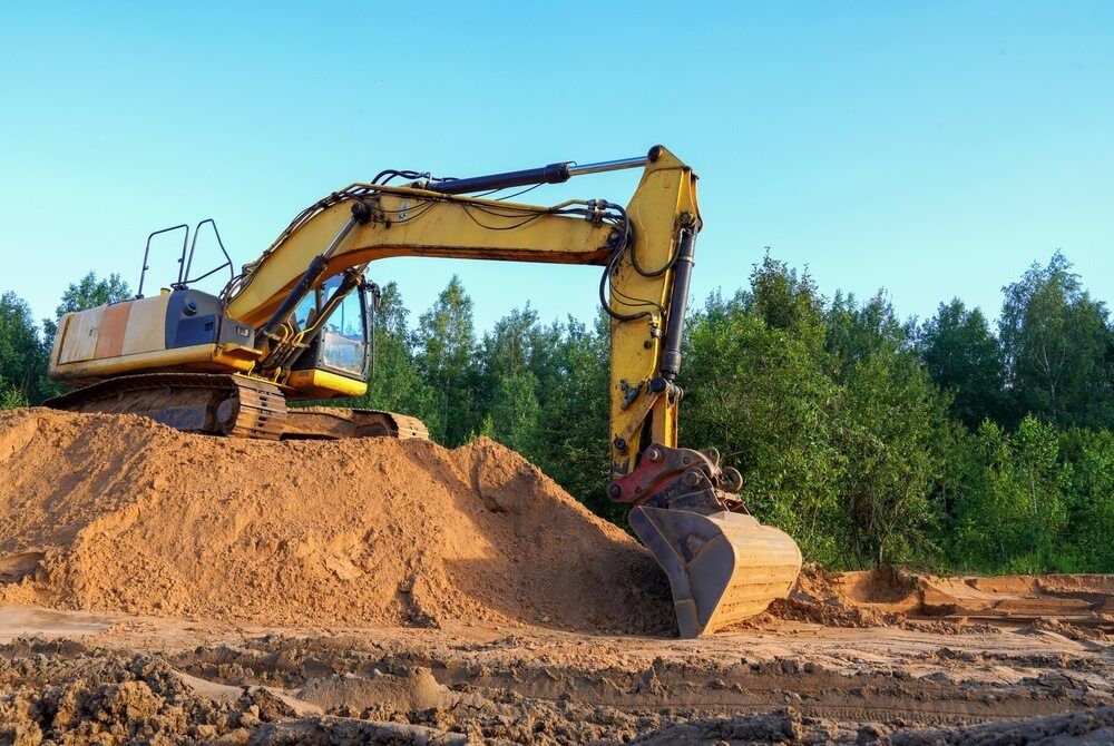 Yellow Excavator on a Sand Pile — STJ Earthmoving in Lockhart River, QLD