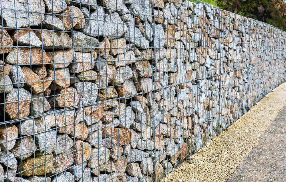 Stone and Wire Gabion Wall Alongside a Gravel Path — STJ Earthmoving in Kuranda, QLD