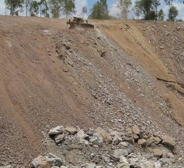 A Bulldozer is Working on a Rocky Hillside — STJ Earthmoving in Mareeba, QLD