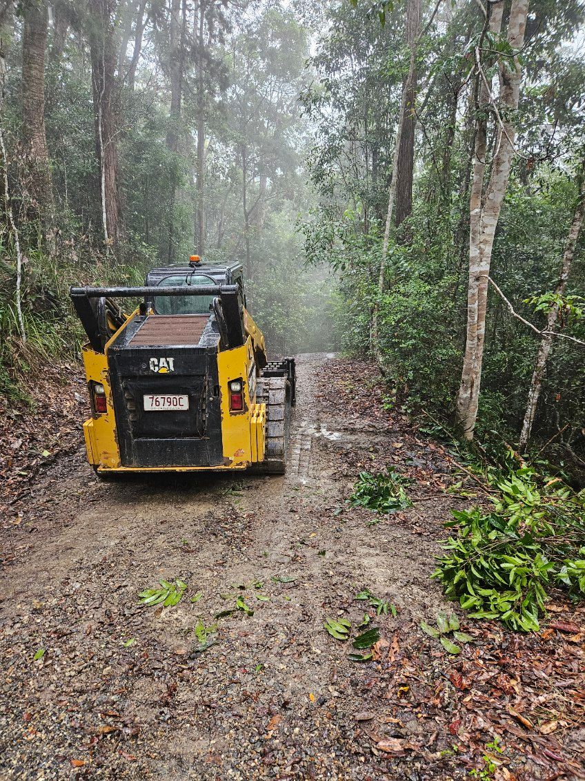 A Bulldozer is Working on a Rocky Hillside — STJ Earthmoving in Mareeba, QLD