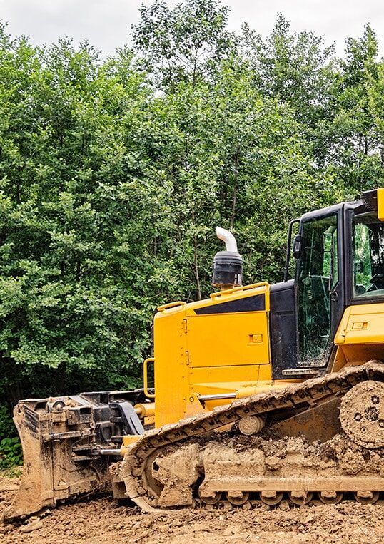 A Bulldozer is Sitting in the Middle of a Dirt Field — STJ Earthmoving in Mareeba, QLD