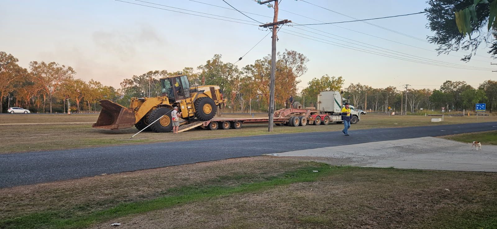 A Yellow Bulldozer on a Flatbed Trailer on a Road — STJ Earthmoving in Mount Molloy, QLD