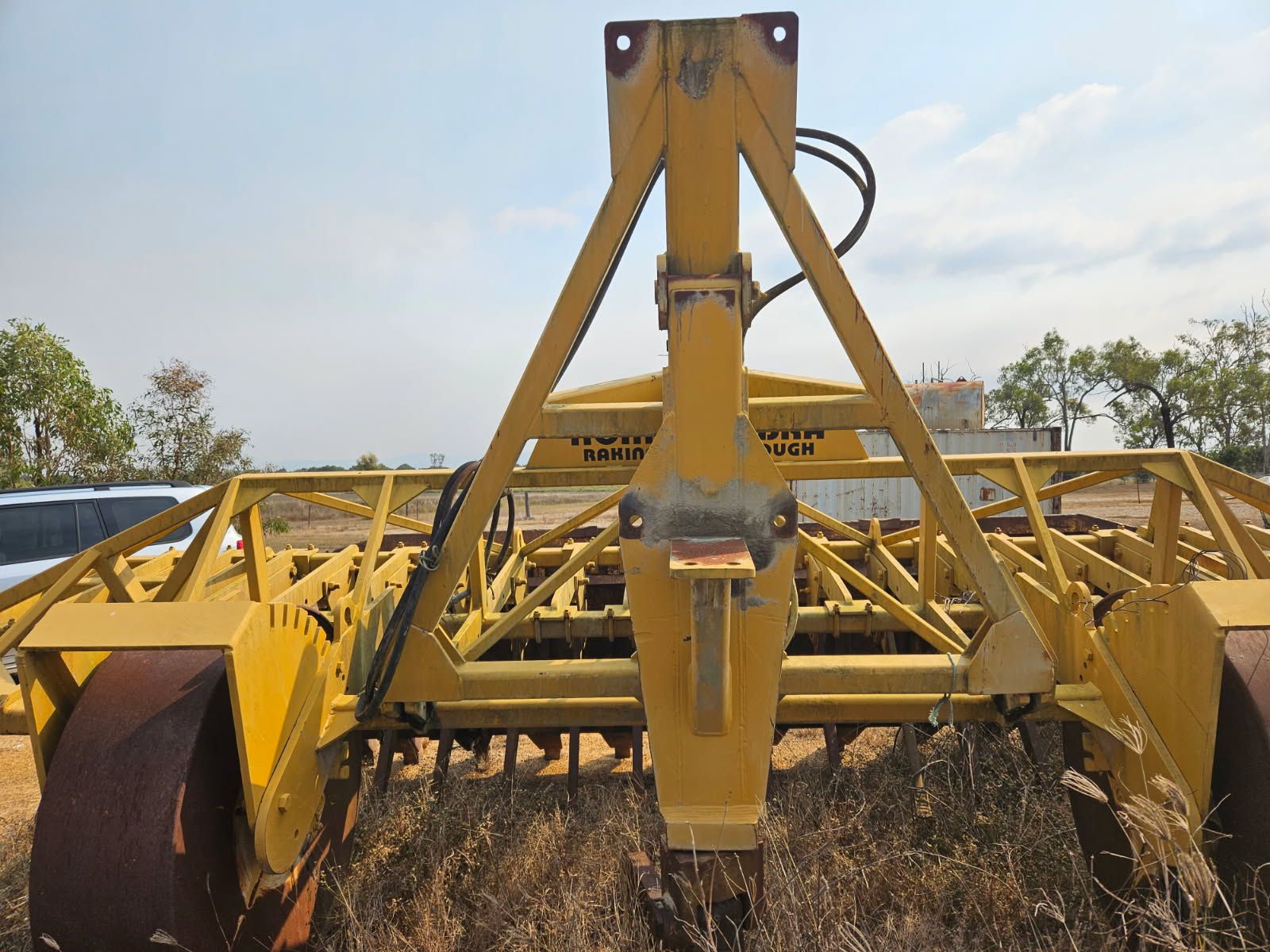Yellow Farm Implement in a Field, With Large Rollers and Triangular Support Frame — STJ Earthmoving in Julatten, QLD
