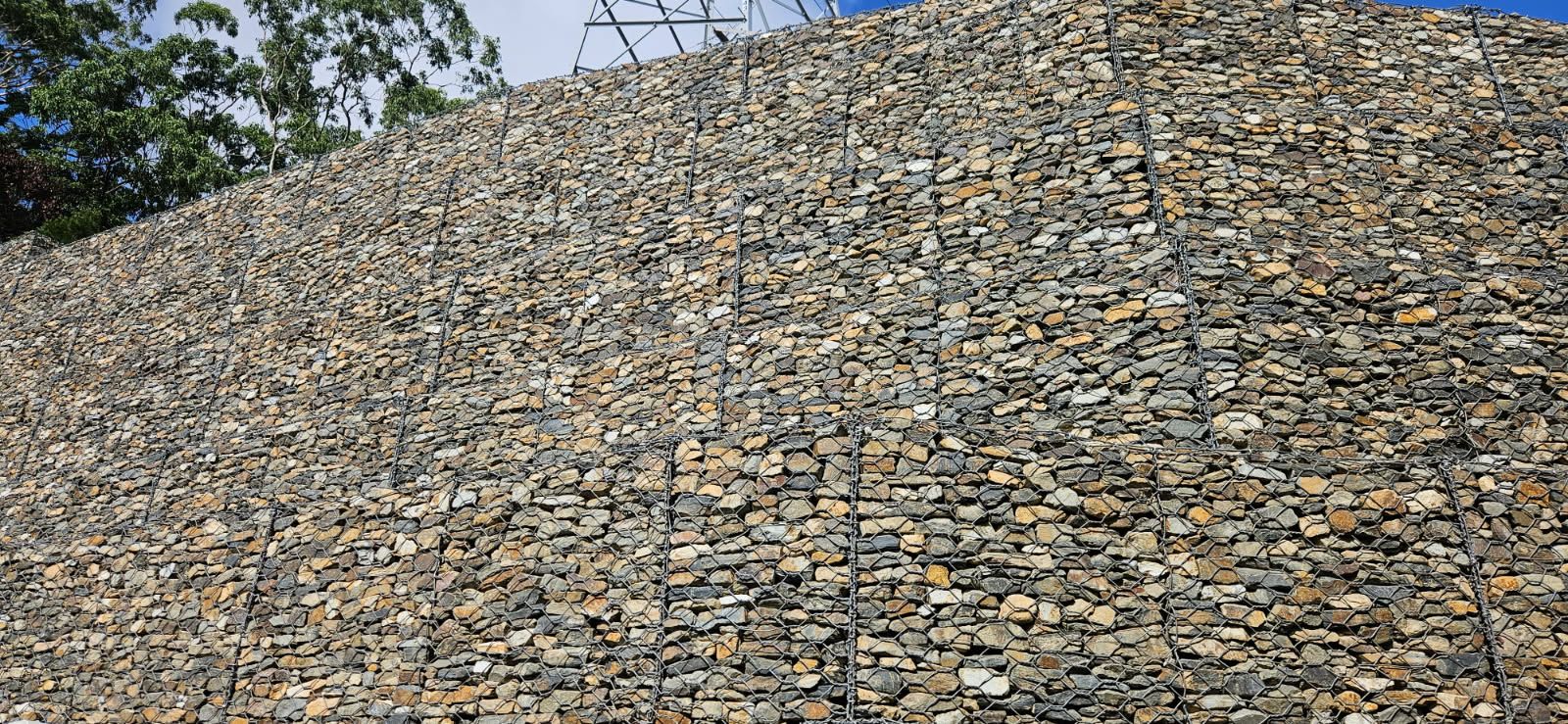 A Large Pile of Rocks Held Together by Wire Mesh — STJ Earthmoving in Burketown, QLD