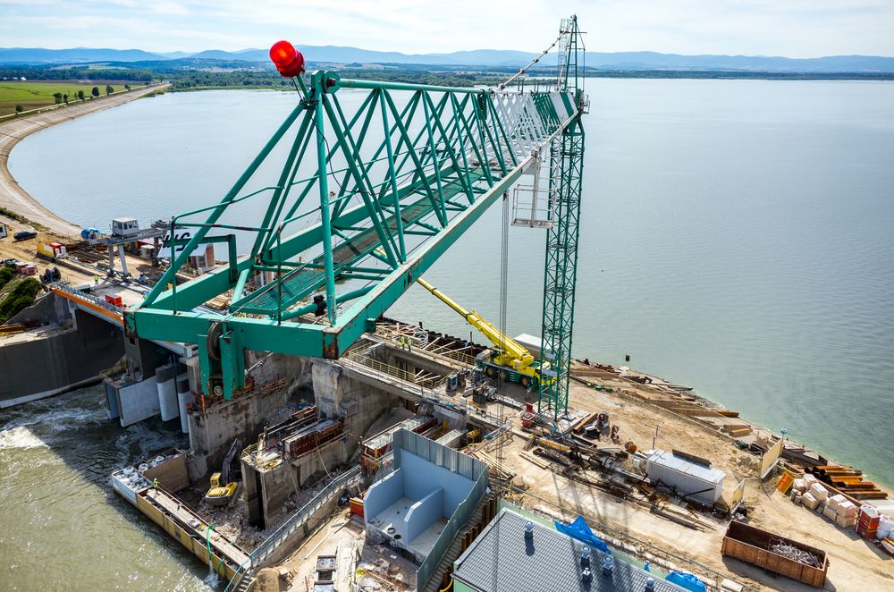 Green Construction Crane Over Water, Building a Dam With Concrete — STJ Earthmoving in Cooktown, QLD