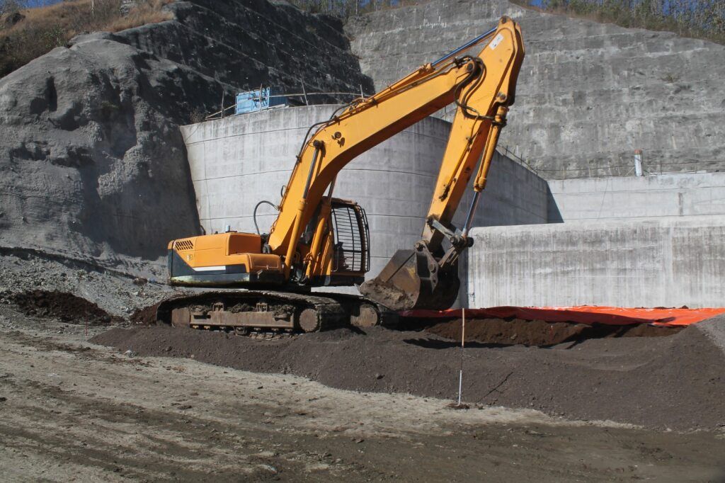 Yellow Excavator Working on a Construction Site — STJ Earthmoving in Archer River, QLD
