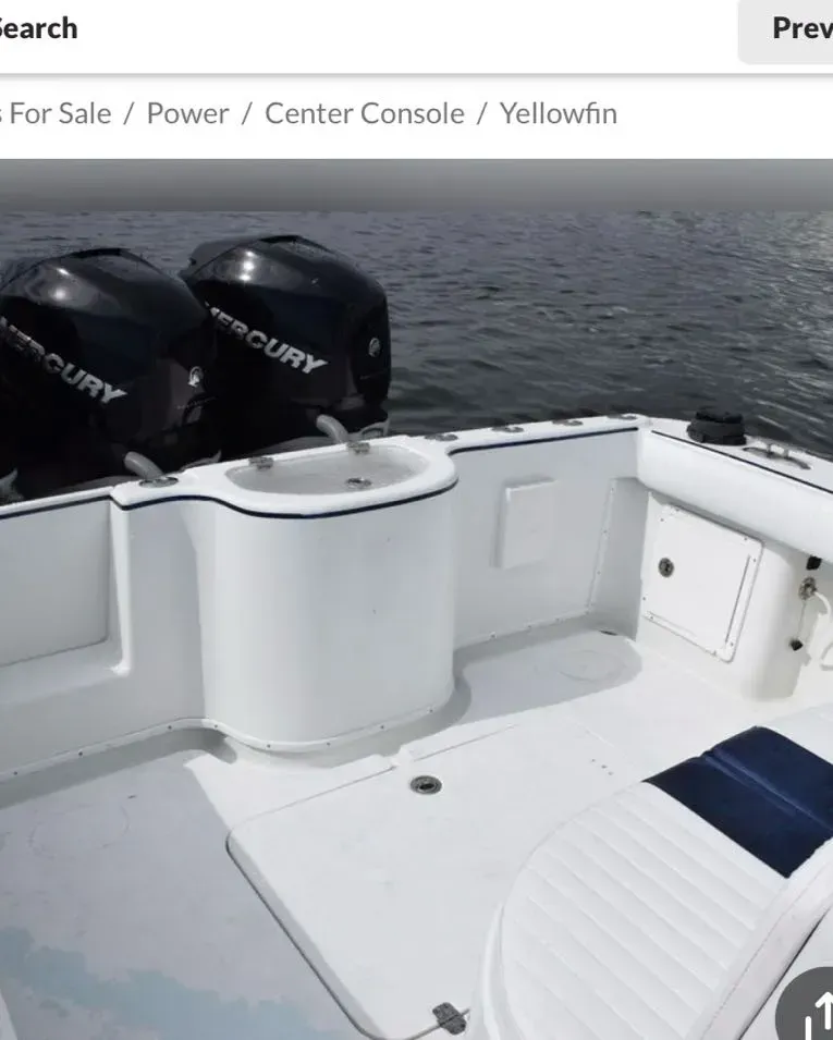 A boat with two mercury engines is for sale