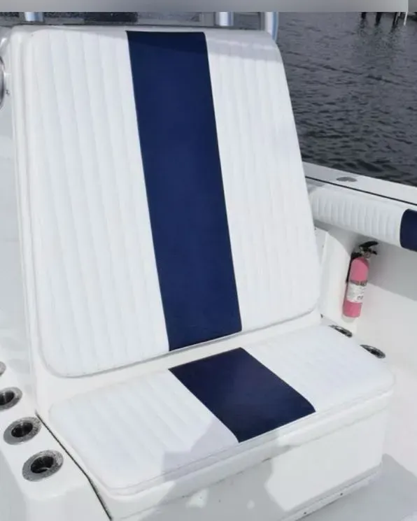 A white boat with a blue stripe on the seat