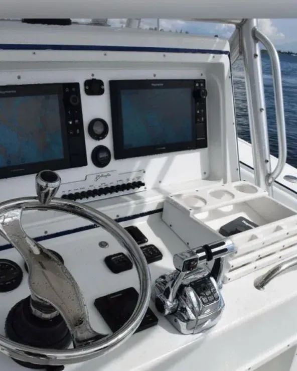 A boat with a steering wheel and monitors on it
