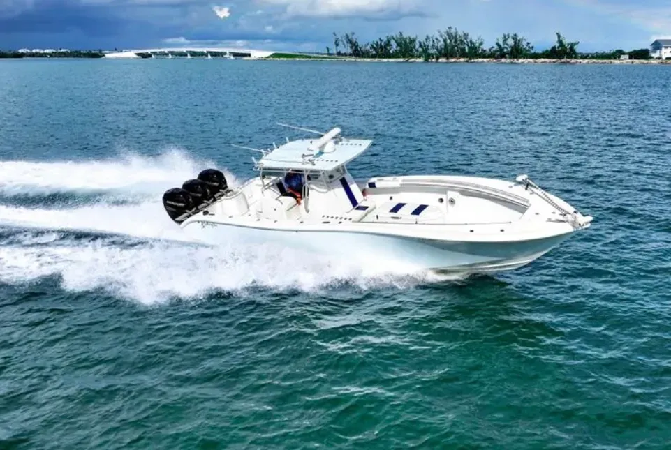 A white boat is floating on top of a body of water.