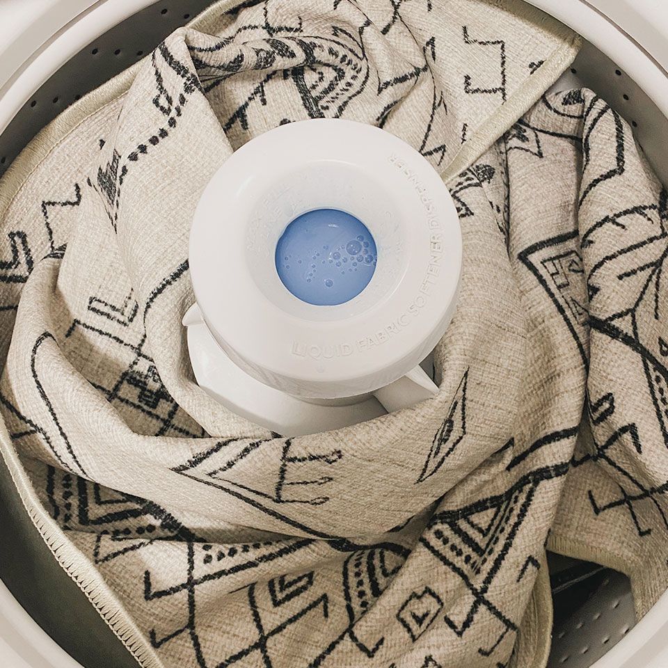A blanket is being washed in a washing machine.